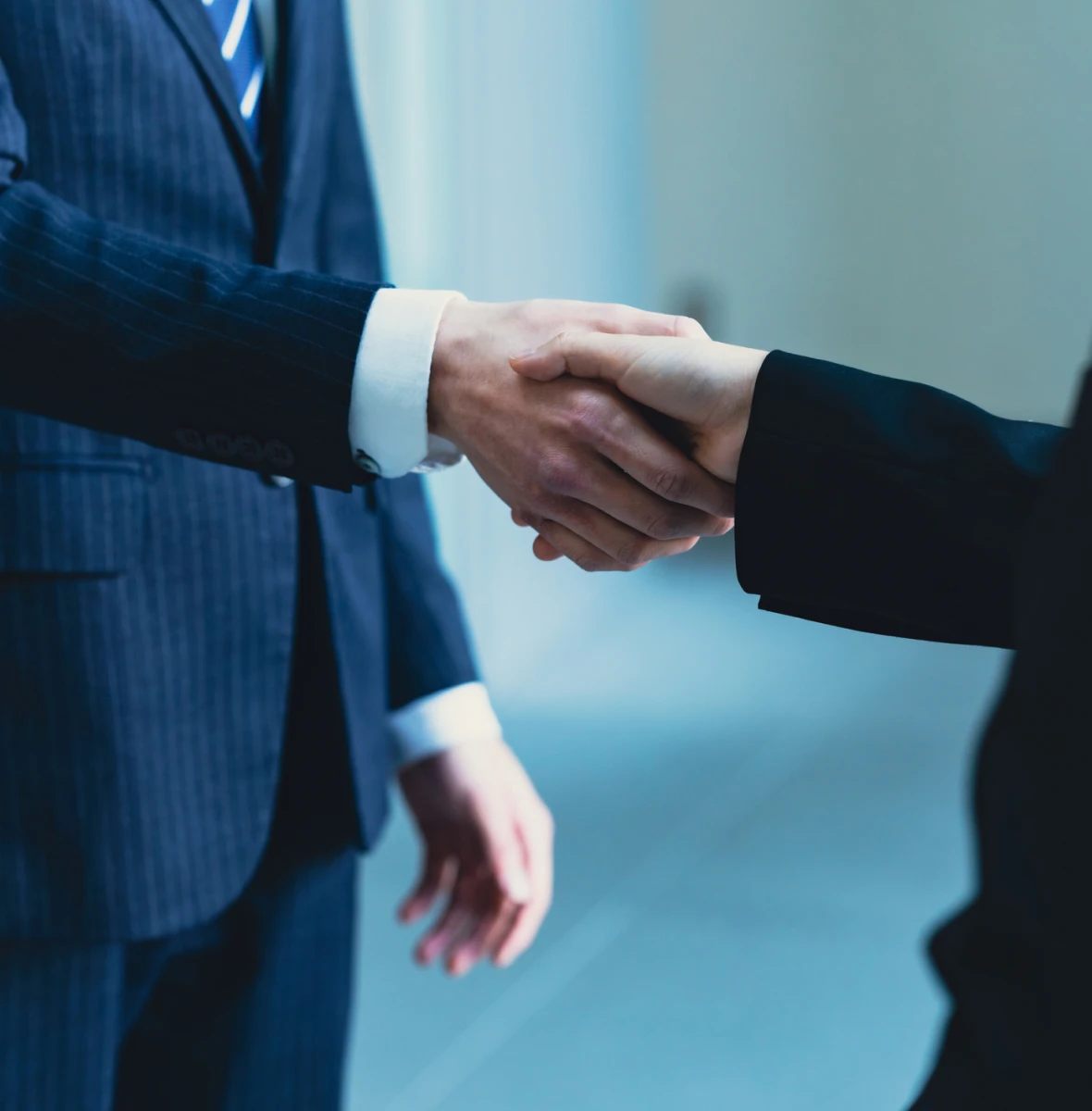 Corporate agreement handshake close-up